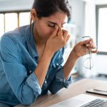Shot of stressed business woman looking worried, tired and overwhelmed.