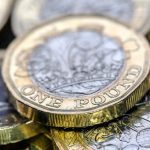 Pound coins scattered on a table