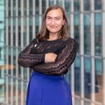 Dana Henželová, who is an AAT member, is pictured with a black top and blue skirt.