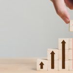 Small blacks with arrows on them which point upwards. As the blocks get higher moving to the left, so does the arrow, therefore resembling a career path