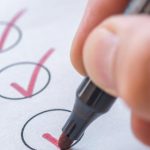 Checklist sheet with pen ticking a box
